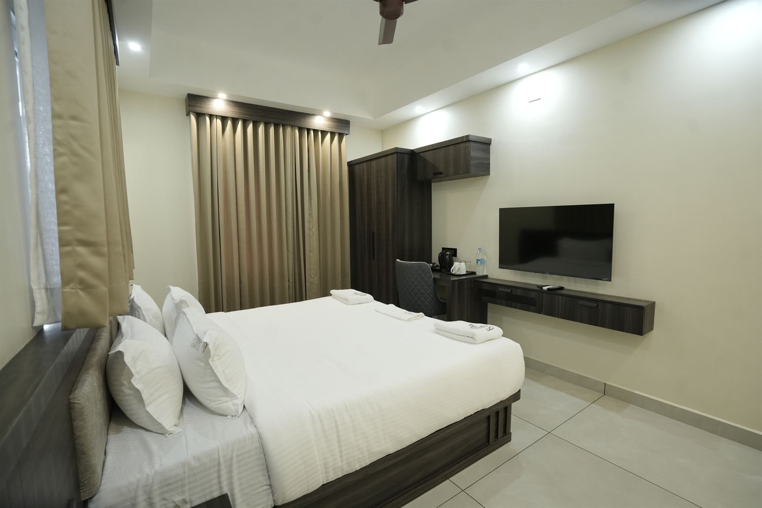 Standard Double Room bed and tv area at Time Square Inn