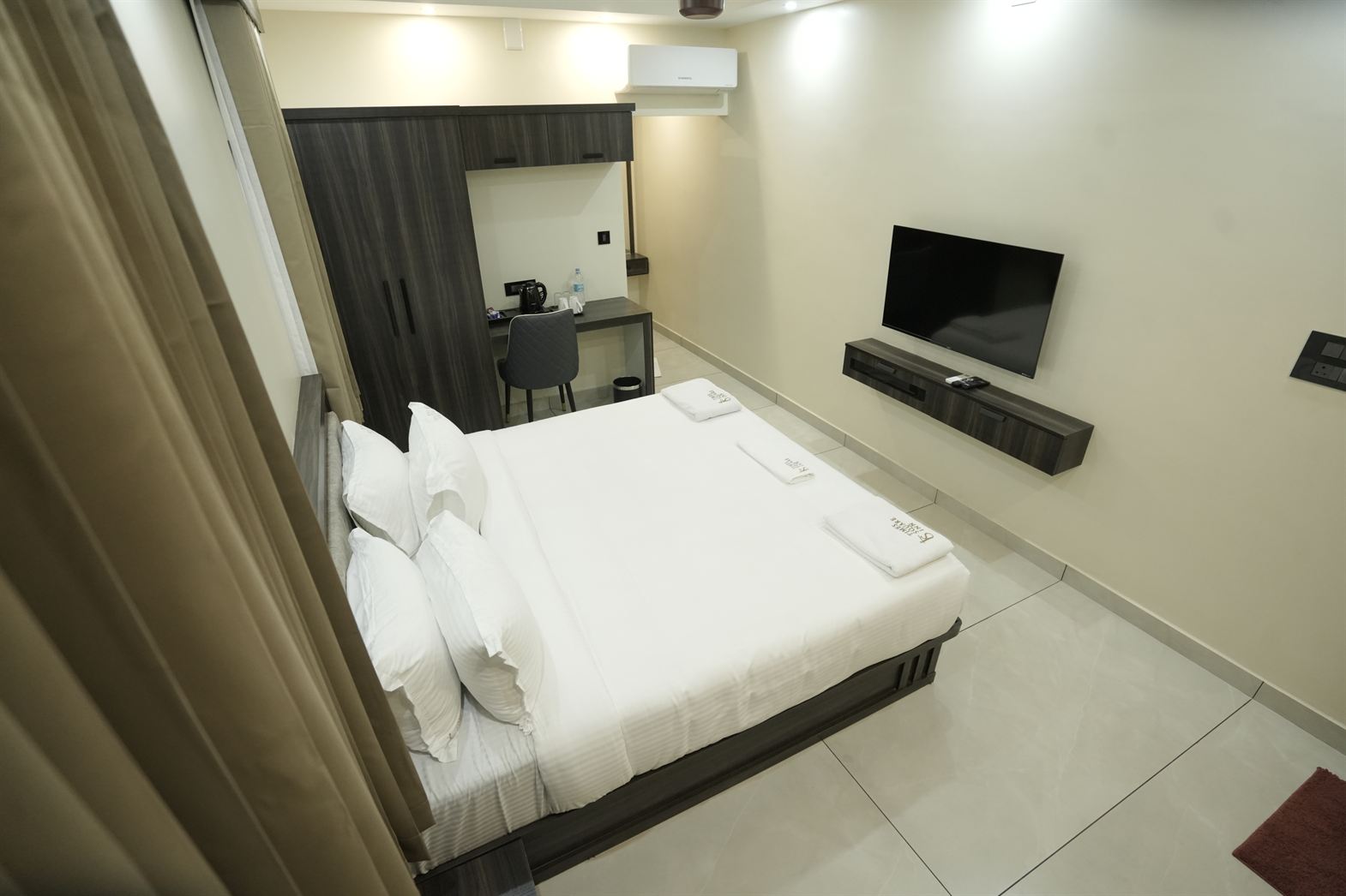 Standard Double Room bed and seating area at Time Square Inn