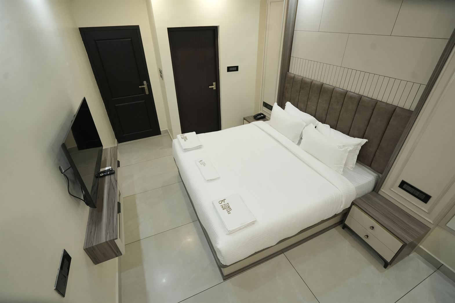 Deluxe Suite bed and spacious layout at Time Square Inn